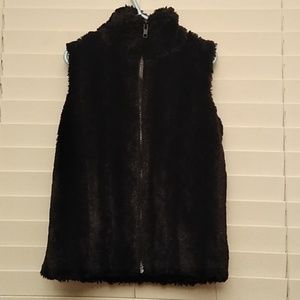 Black fuzzy vest, with zipper.